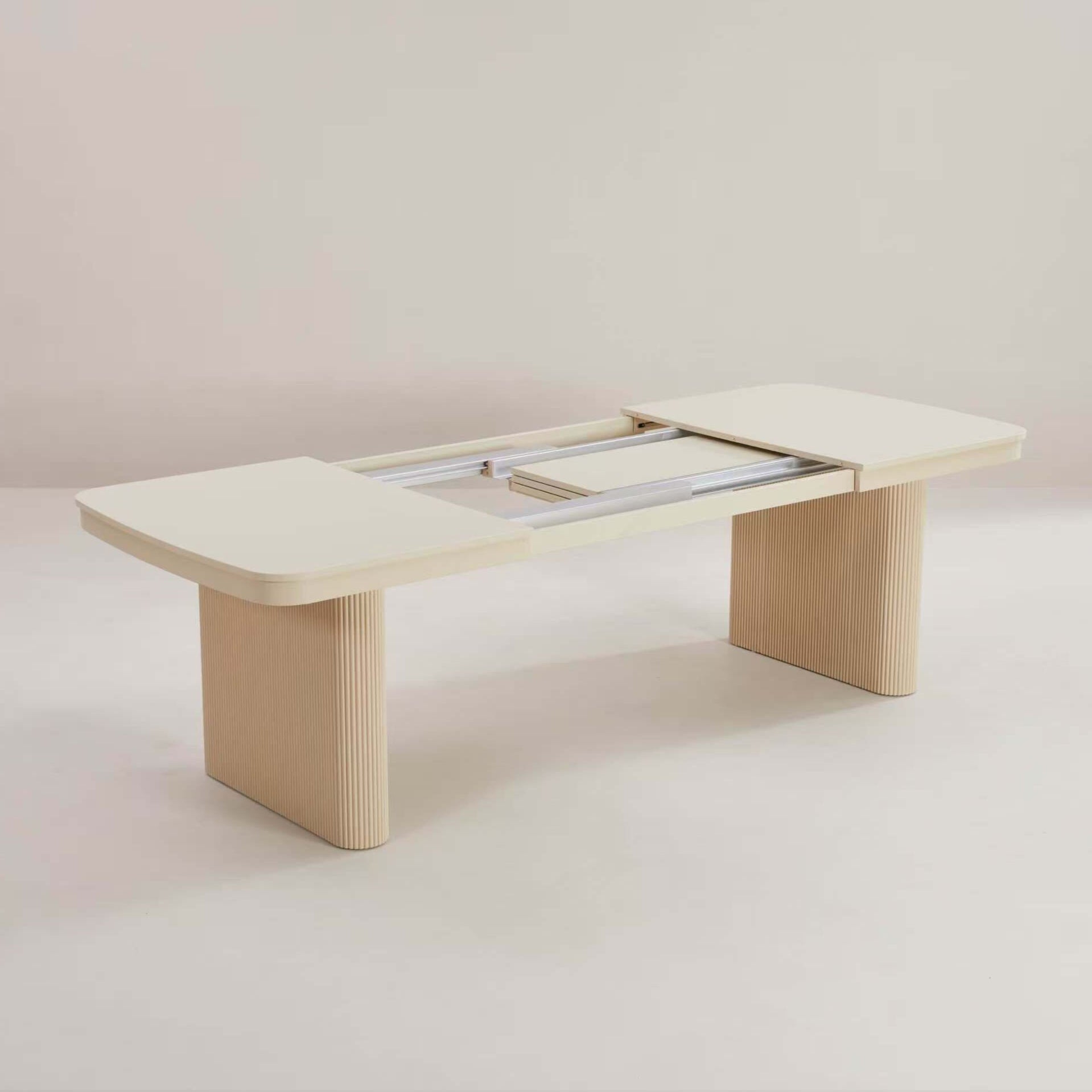 Fluted wood rectangular curved extending table with storage leaflets inside.