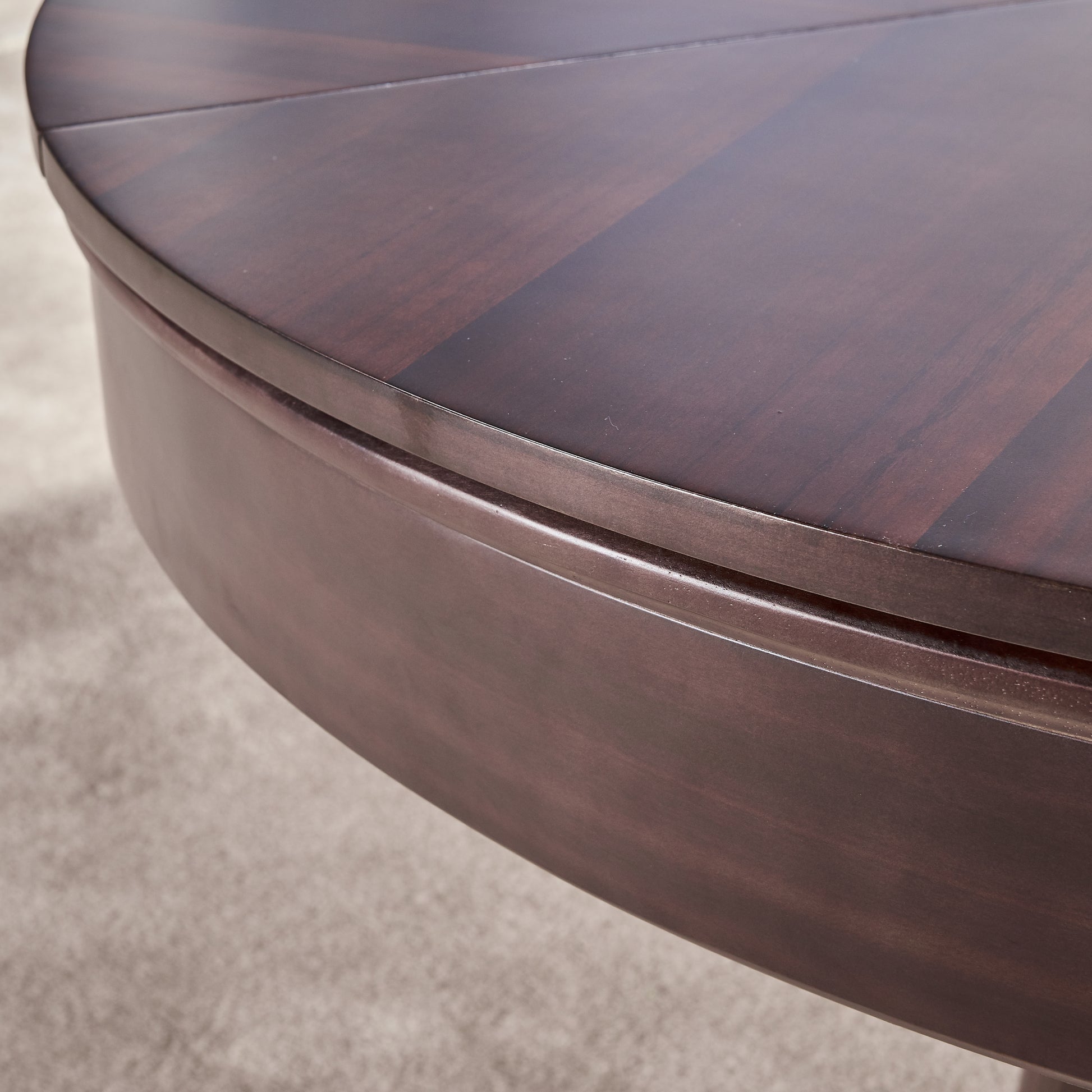 Close up of compass round expanding table top in walnut with base