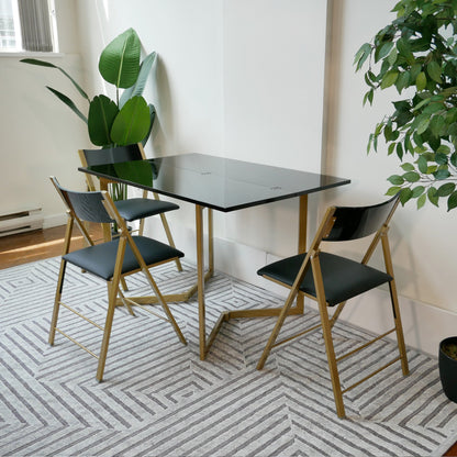 Flip-console-table-glossy-black-with-gold-legs-and-black-nano-chairs-in-grey-room