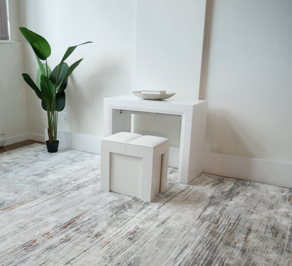 Mini Scatola in white being used as a seat in front of the junior giant white glossy console