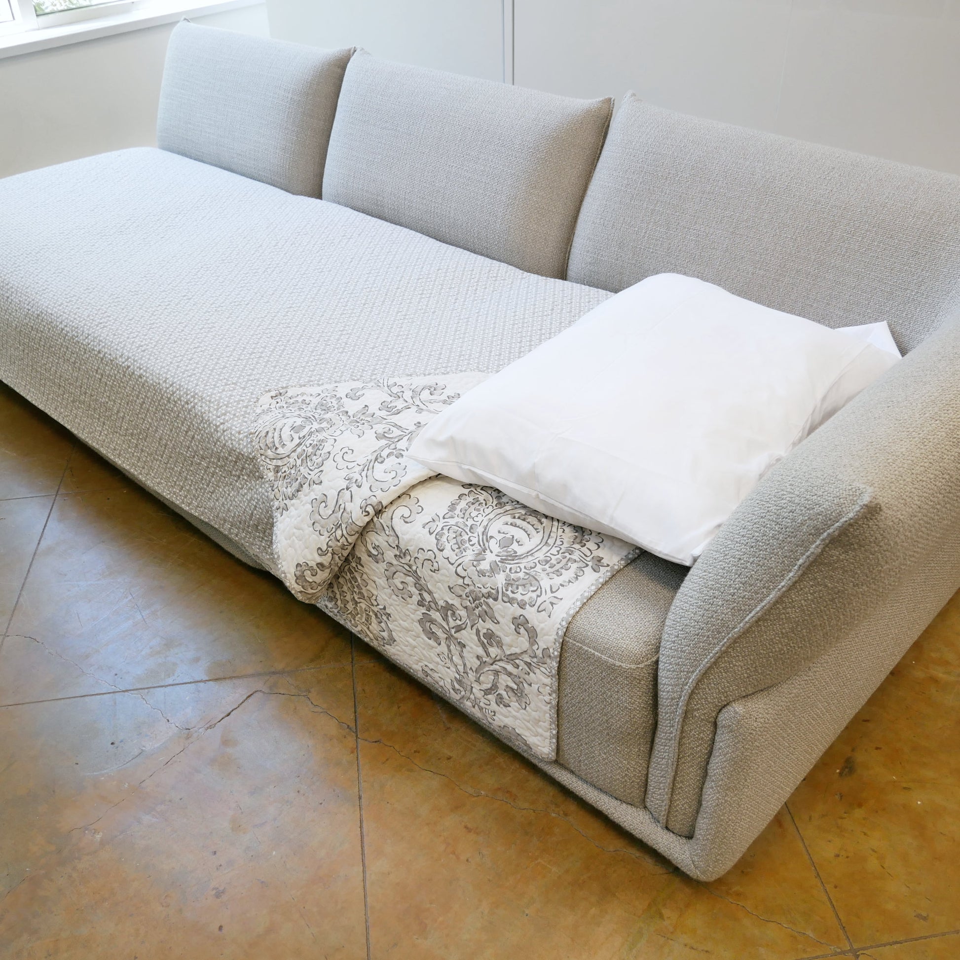 Stratus sofa used as a sofa bed for its flat surface and deep seats