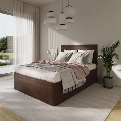 Modern bedroom with a wooden lift store bed, white bedding, and decorative pillows.