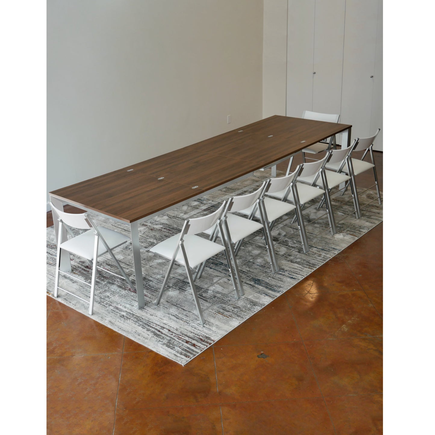 mega-abode-super-extended-14-person-table-in-chocolate-walnut-with-silver-legs-and-nano-chairs-around-it