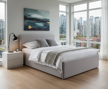 Modern bedroom with a grey lift storage bed, nightstand, and city view