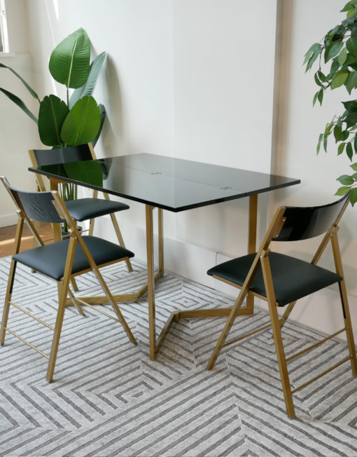 Flip-console-table-glossy-black-with-gold-legs-and-black-nano-chairs-in-grey-room