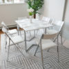 Flip-console-table-in-glossy-white-opened-in-dining-form-with-six-nano-chairs-in-a-modern-room-with-grey-carpet