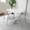 Flip-console-to-dining-table-in-glossy-white-opened-in-dining-form-with-4-nano-chairs-in-a-modern-room-with-grey-carpet