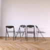 Magro-Thin-Grey-Folding-Chairs-in-white-room-with-trendy-wood-floor-Expand-Furniture