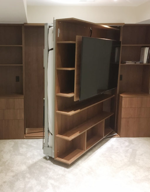 revolving-wall-bed-tv-example-with-walnut-finish-custom-build-with-large-tv-being-swiveled-closed