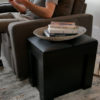 Black Mini Scatola Next to a Sofa used as a side table