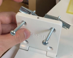insert bolts through the folding hook into anchors
